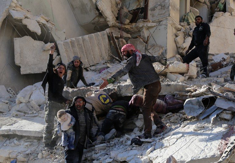 Civilians and rescue workers remove a toddler and search for other victims amid the rubble of a building following a reported air strike by Syrian government forces on the Sukkari neighborhood of Syria's northern city of Aleppo on December 7, 2015. Syria's nearly five-year war has left more than 250,000 dead and forced some 12 million people from their homes. / AFP / BARAA AL-HALABI
