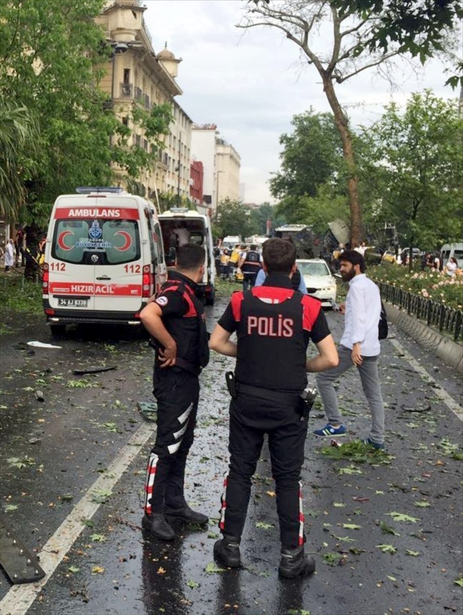 Policemen keep guard as the ambulances arrive at the site after an explosion took place in Beyazit district of Istanbul, Turkey on June 07, 2016.