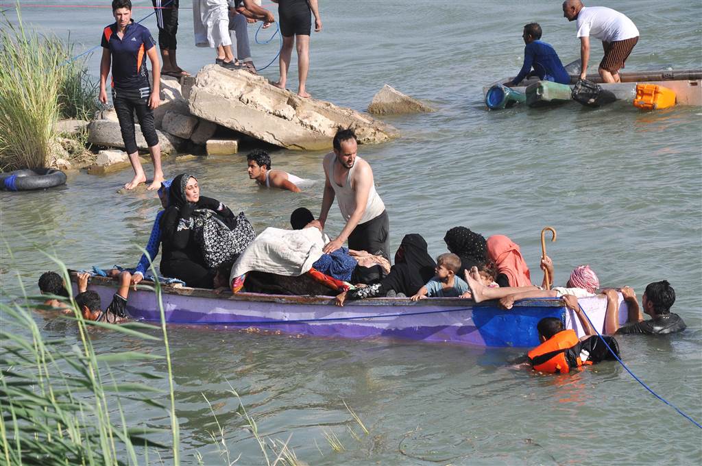 Internally displaced civilians from Fallujah flee their homes by crossing Euphrates River on a boat heading to a safe haven during fighting between Iraqi security forces and ISIS on June 2