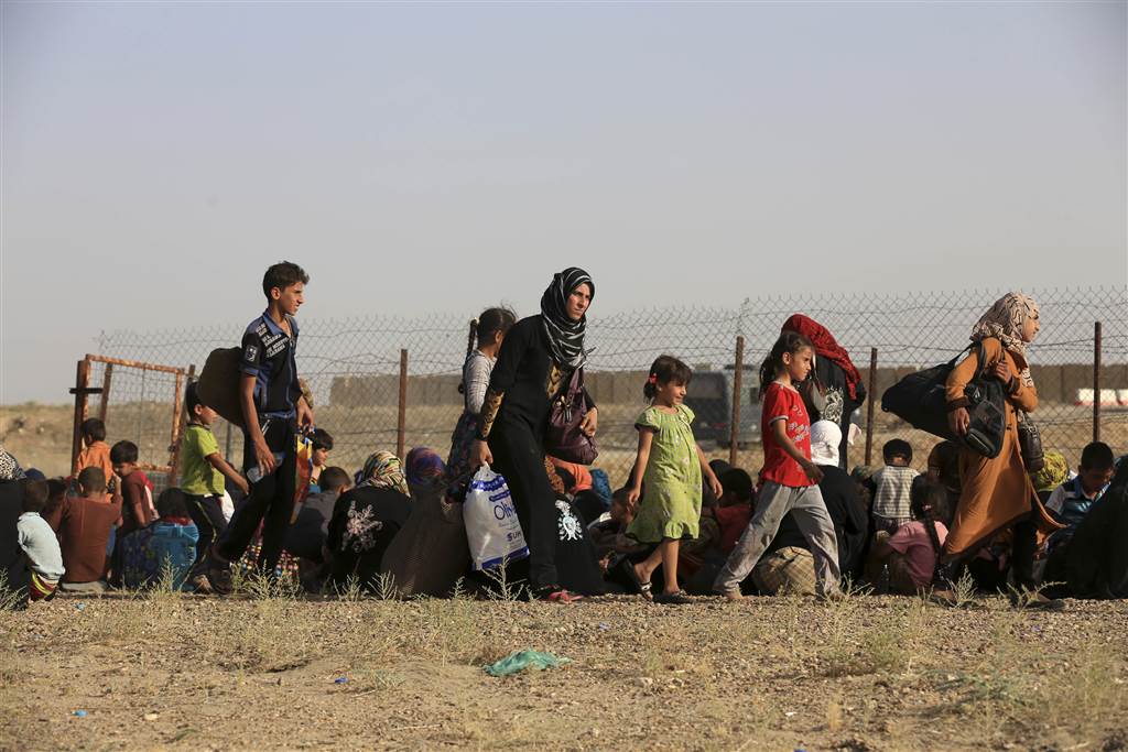 Iraqi families gather outside an Iraqi military camp near Fallujah on June 3