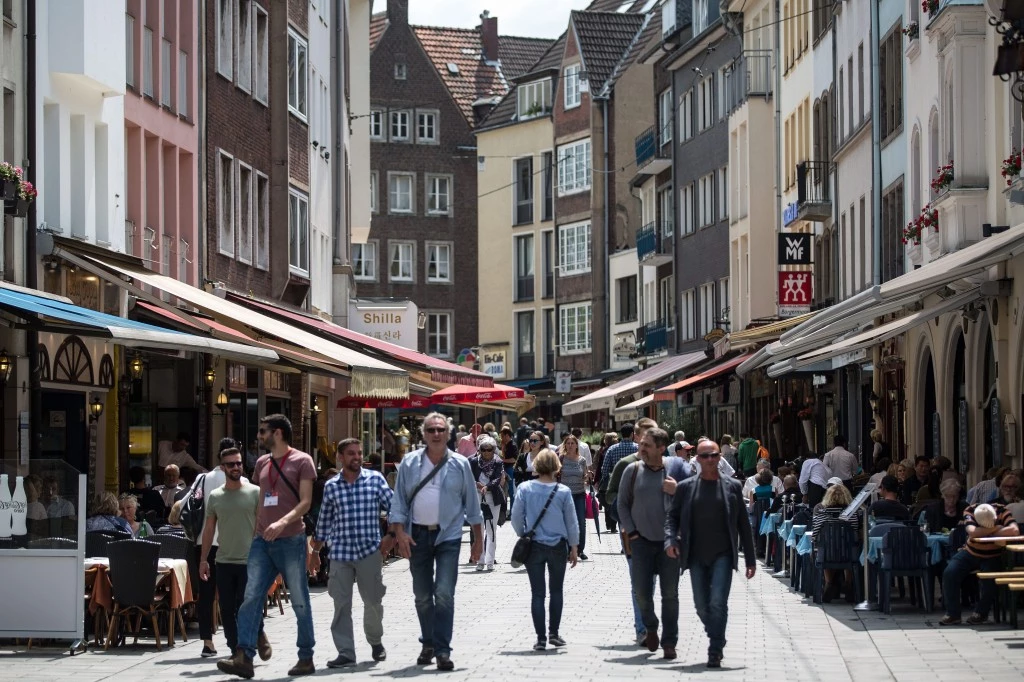 People walk through Düsseldorf’s Old Town on Thursday. A German terrorist cell was allegedly planning an attack on the historic town center.