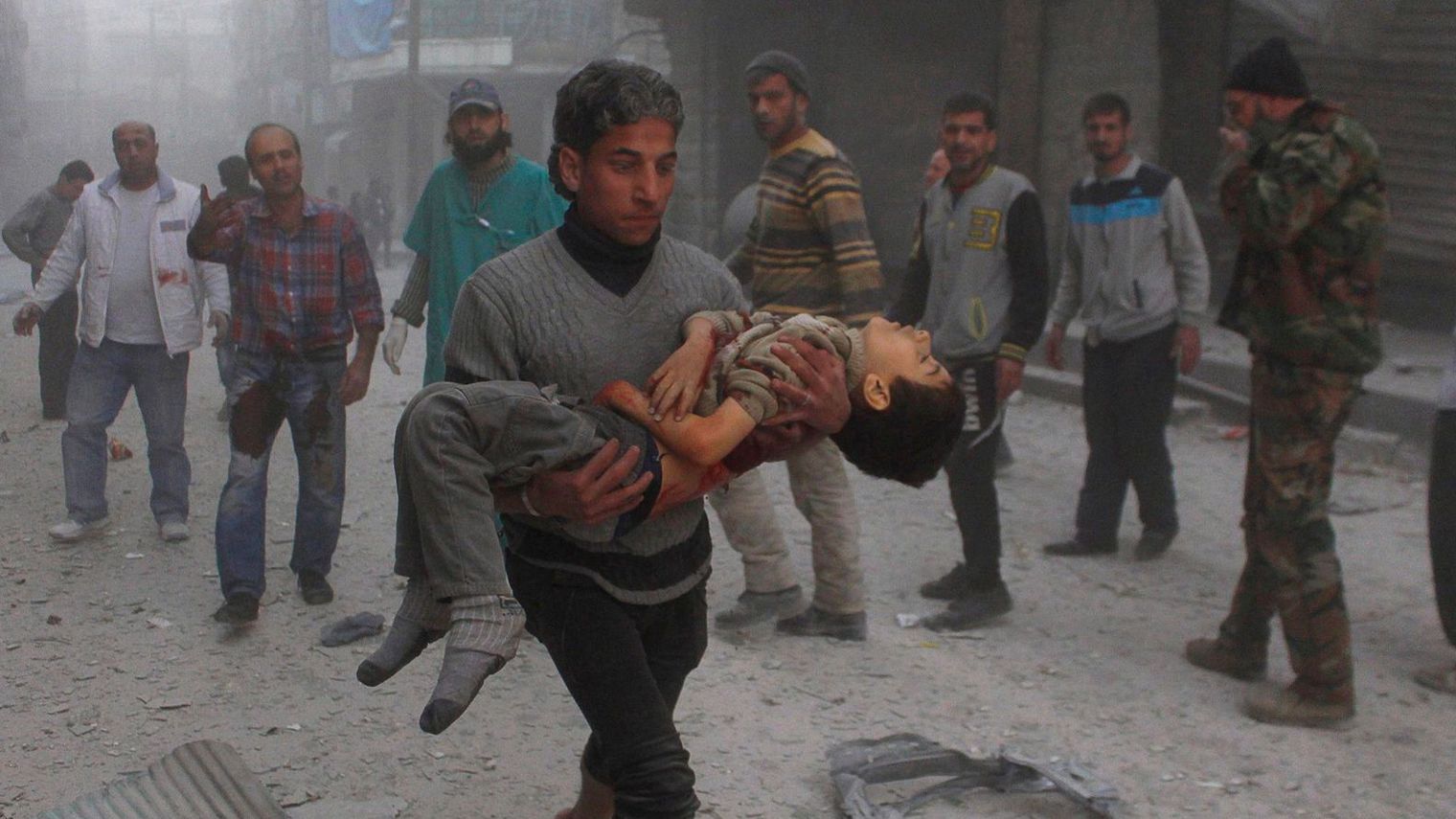 a-man-carries-a-child-injured-by-what-activists-said-were-barrel-bombs-dropped-by-warplanes-loyal-to-syria-s-president-assad-in-aleppo_5156375