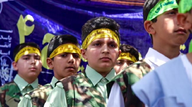 Children wearing the yellow headbands of suicide bombers at the protest in Shiraz