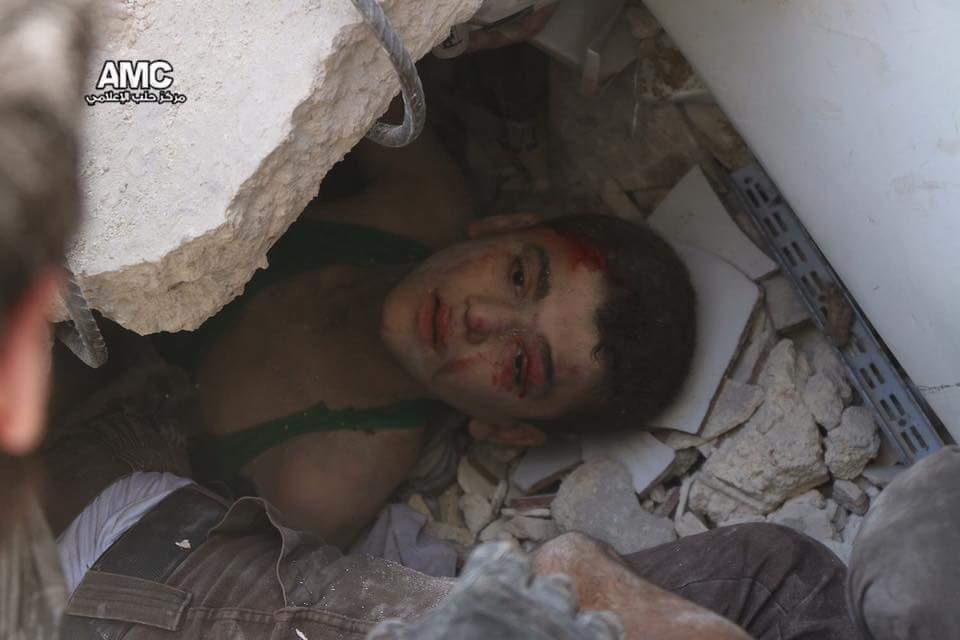 A boy trapped under the rubble after Assad-Russian airstrikes on Aleppo
