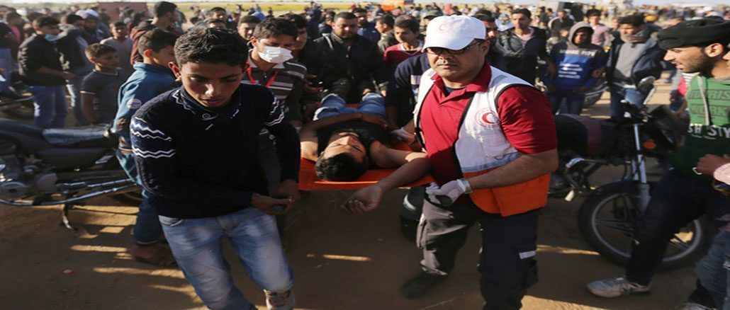 A Palestinian is evacuated during clashes with Israeli troops at the Gaza-Israel border at a protest demanding the right to return to their homeland, in the southern Gaza Strip